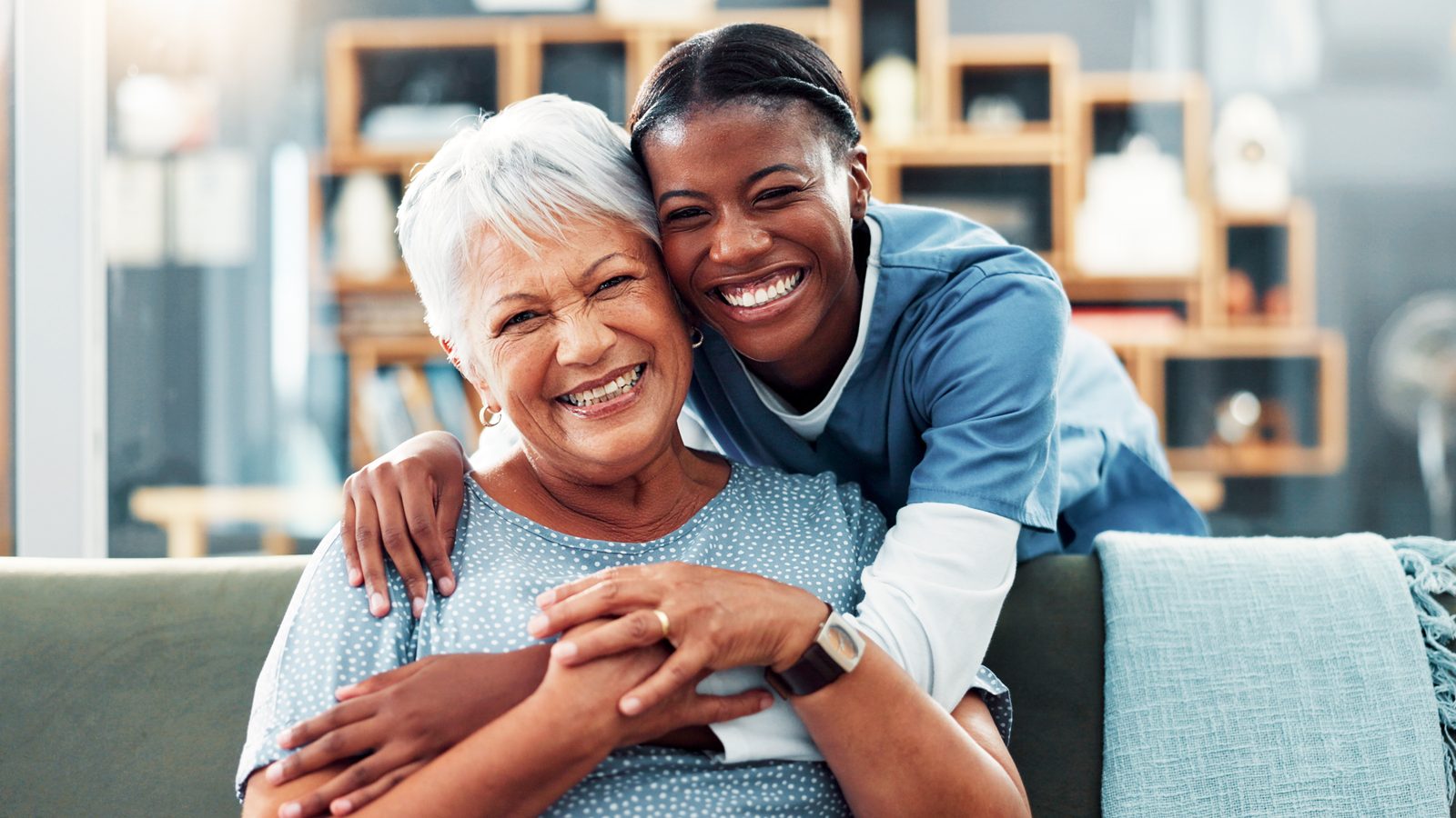 A Gentle Hands caregiver hugging a smiling senior woman